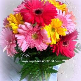 Bouquet of colorful gerbera daisies with green foliage
