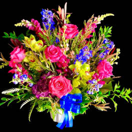 Bright mixed bouquet of pink roses, blue flowers, and yellow orchids