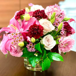 Pink and white mixed bouquet in a clear glass vase