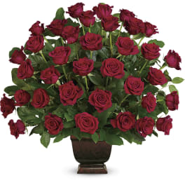 Large bouquet of red roses in a dark vase
