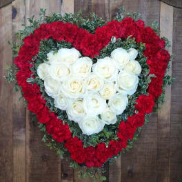 Heart-shaped floral arrangement with white roses and red carnations
