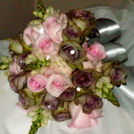 Bouquet of pink and purple roses with silver ribbon wrap