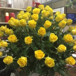 Large bouquet of yellow roses in a shop setting