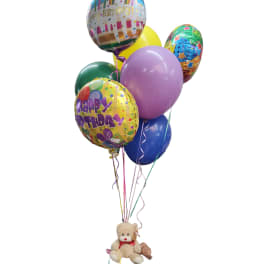 Birthday balloons with a teddy bear attached