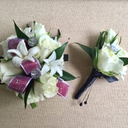 White floral bouquet and matching boutonniere with pink ribbon accents