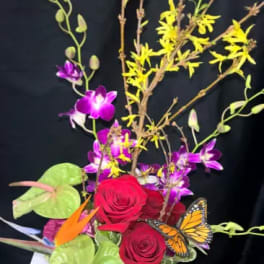 Bouquet with red roses, purple orchids, and a butterfly accent