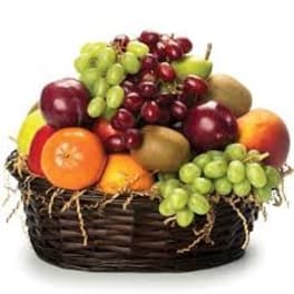 Basket of assorted fruit including grapes, apples, and kiwi
