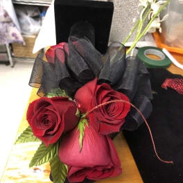Red roses with black ribbon in a small bouquet