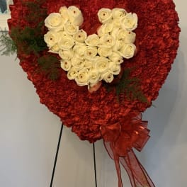 Heart-shaped red floral standing arrangement with white roses