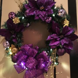 Purple decorated wreath with bows and ornaments