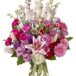Mixed pink and purple bouquet in a clear glass vase