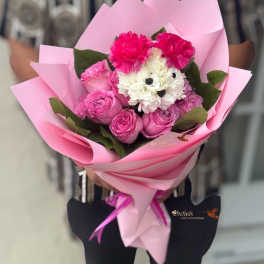 Pink bouquet with roses, carnations, and white flowers wrapped in pink paper