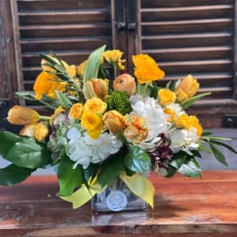 Yellow and white mixed bouquet in a square vase with ribbon