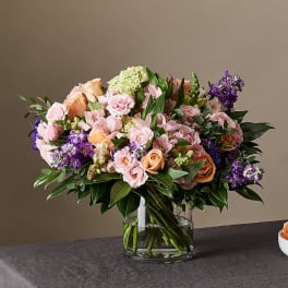 Mixed pink and purple flower bouquet in a glass vase