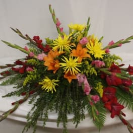 Colorful floral centerpiece with red, orange, and yellow blooms