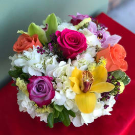 Colorful bouquet with roses, hydrangeas, and a yellow orchid