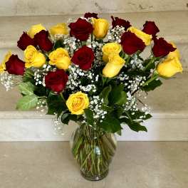 Bouquet of red and yellow roses in a glass vase
