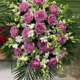 Lavender rose and white orchid standing spray with palm fronds