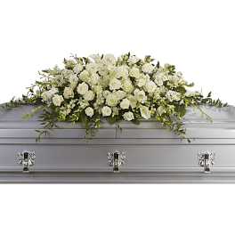 White rose casket spray with trailing greenery