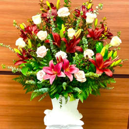 Large bouquet of lilies and roses in a white vase