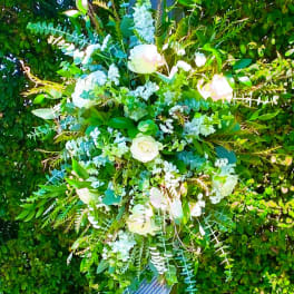 Large floral arrangement with white roses and pale blue flowers