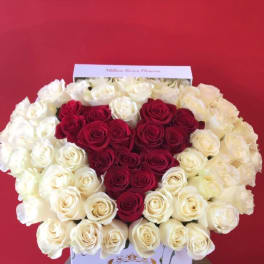 Heart-shaped red and white rose arrangement in a white box