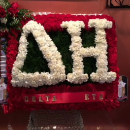 Red and white floral fraternity display with Delta Eta lettering