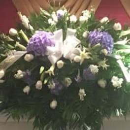 Large funeral spray with purple and white flowers
