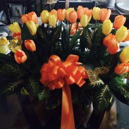 Bouquet of orange and yellow tulips with a large orange ribbon