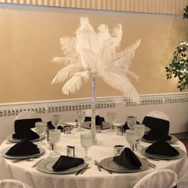 Tall white feather centerpiece on a banquet table