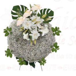 White floral wreath with lilies and baby’s breath