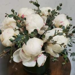 White peony bouquet with eucalyptus in a dark vase