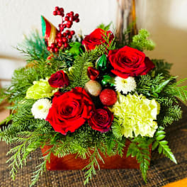 Red roses and white flowers in a festive holiday arrangement