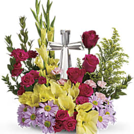 Bouquet of magenta roses, yellow calla lilies, and lavender daisies with a silver ribbon