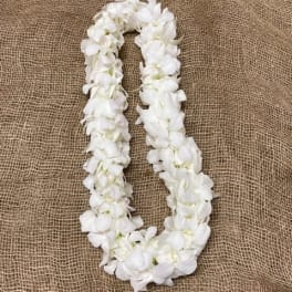 White flower lei on burlap fabric