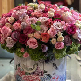 Large bouquet of pink and lavender roses in a decorative box