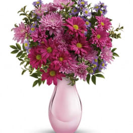 Pink and purple bouquet in a pink glass vase