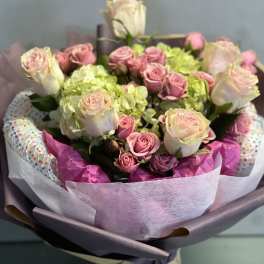 Bouquet of pink roses and green hydrangeas wrapped in pastel paper