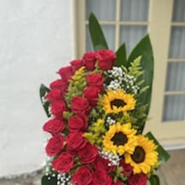 Bouquet of red roses and sunflowers with white filler flowers
