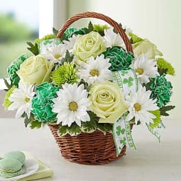 Basket of white daisies and pale yellow roses with green accents