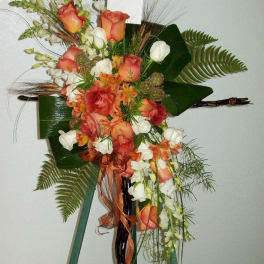 Tall floral spray with peach roses and white blooms on a stand