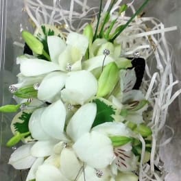 White lily bouquet with green buds and ribbon streamers