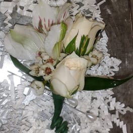 White rose and lily bouquet with small white filler flowers