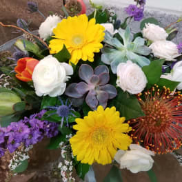 Mixed bouquet with yellow gerbera daisies, white roses, and purple flowers
