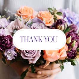 Bouquet of peach, lavender, and purple flowers with a thank you card