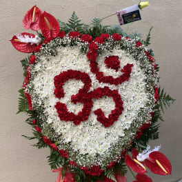 Heart-shaped floral standing spray with red and white flowers and red anthuriums