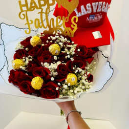 Bouquet of red roses with gold-wrapped chocolates and a red cap