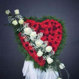 Heart-shaped red floral spray with white roses and greenery