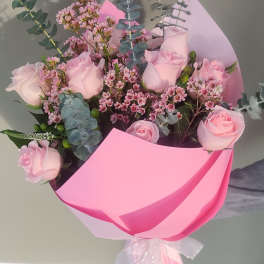 Pink rose bouquet wrapped in bright pink paper