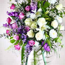 Tall mixed bouquet with pink and white roses, lilies, and purple flowers